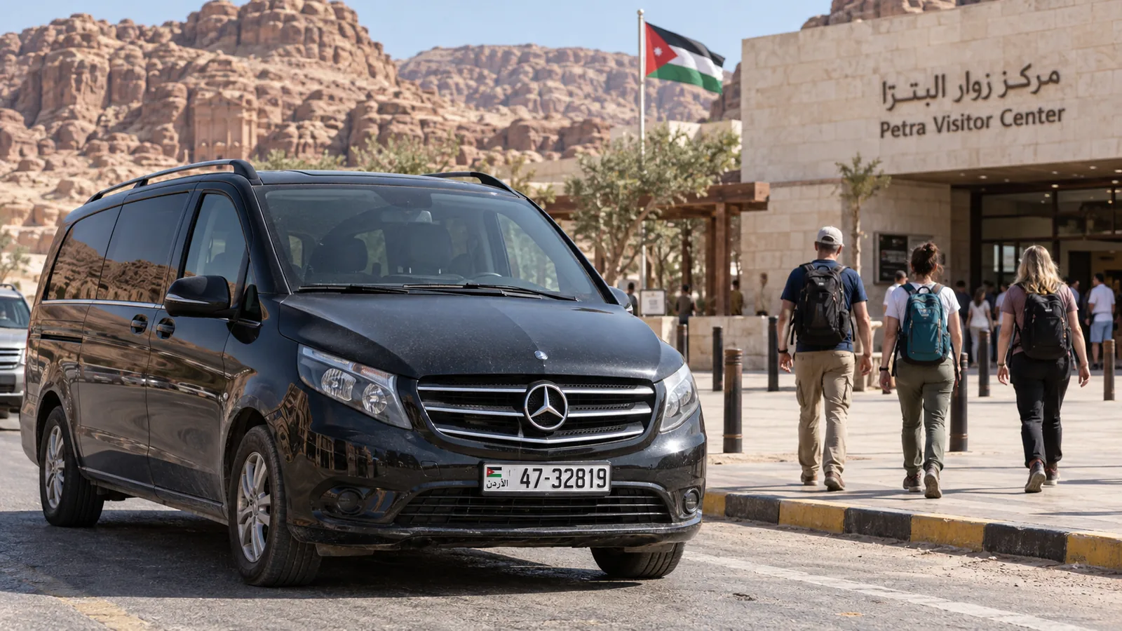 A Mercedes-Benz Vito parked near the Petra visitor center with adult travelers.
