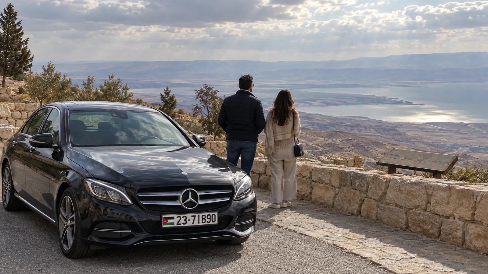 A Mercedes-Benz sedan at the Mount Nebo viewpoint above the Dead Sea valley.