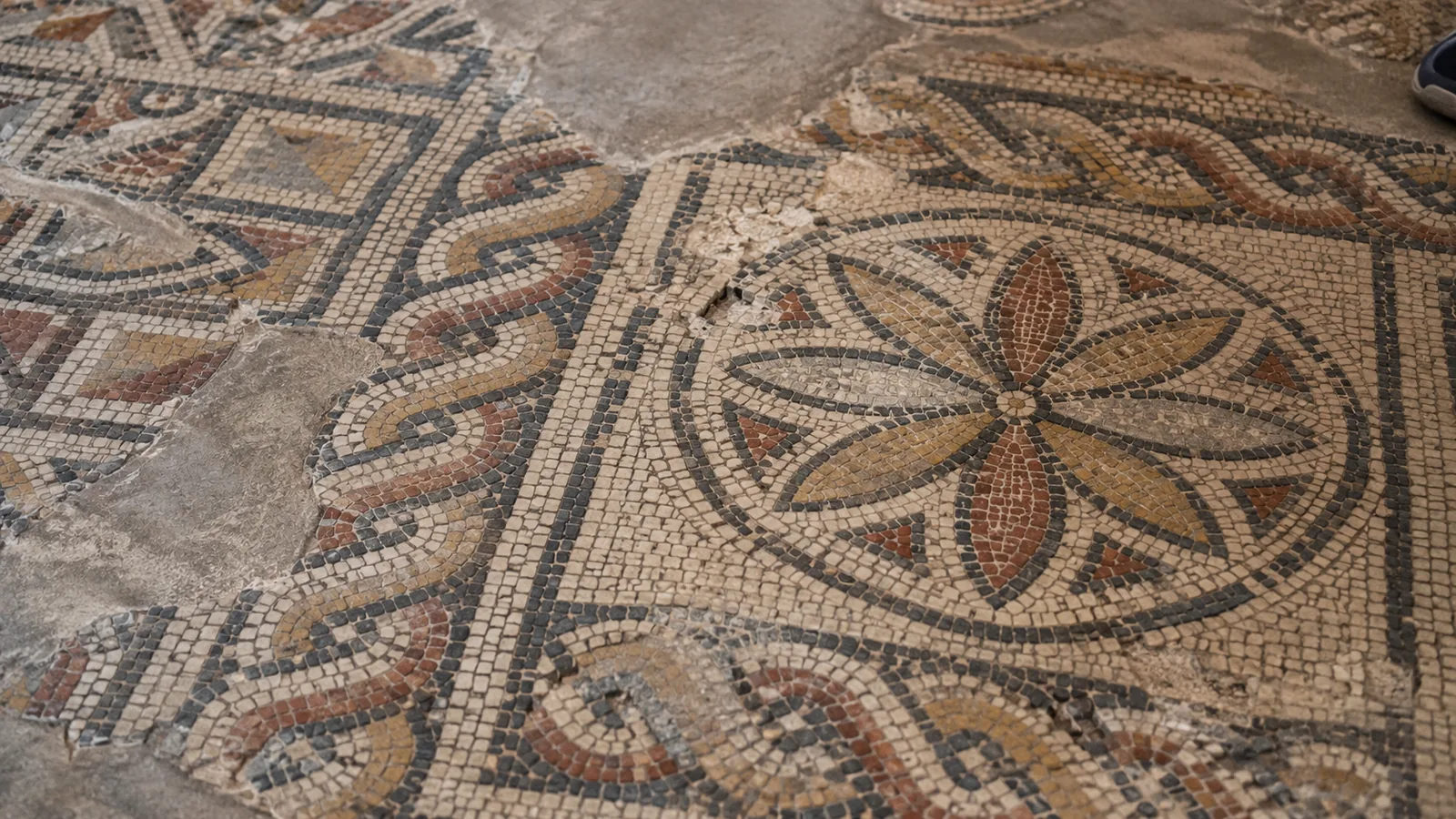 Close detail of the weathered geometric mosaic floor in Madaba.